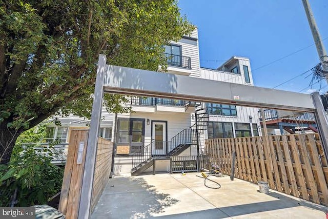 rear view of property with a balcony