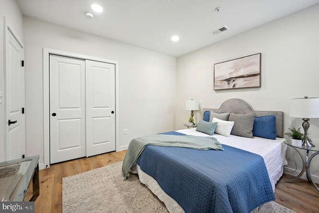 bedroom featuring hardwood / wood-style floors and a closet