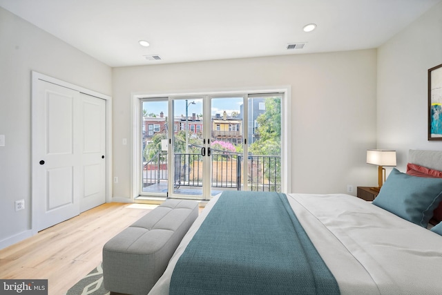 bedroom featuring access to outside, a closet, and light hardwood / wood-style floors