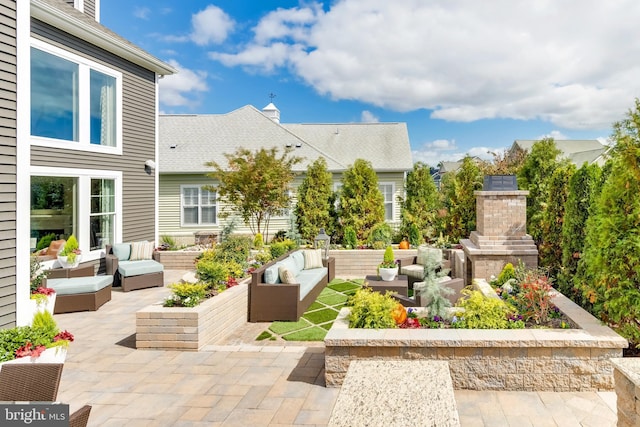 view of patio / terrace featuring an outdoor living space with a fireplace