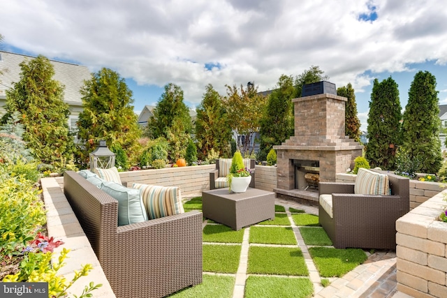 view of patio / terrace with an outdoor living space with a fireplace