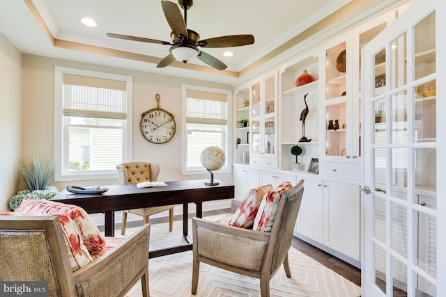 home office featuring ceiling fan, crown molding, and a tray ceiling