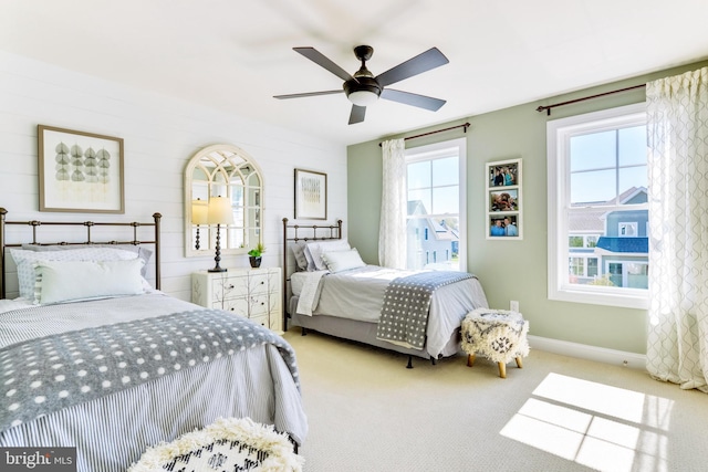 bedroom with ceiling fan and light carpet