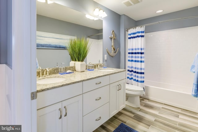 full bathroom featuring toilet, vanity, and shower / bath combo with shower curtain