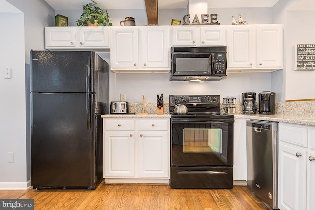 kitchen featuring light stone counters, light hardwood / wood-style flooring, white cabinets, and black appliances