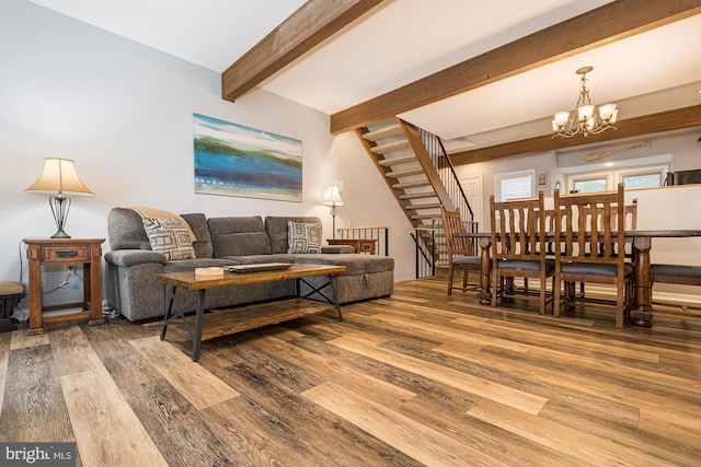 living room with beamed ceiling, hardwood / wood-style flooring, and a notable chandelier