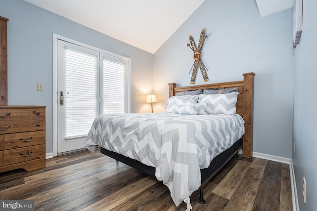 bedroom featuring multiple windows, dark hardwood / wood-style floors, and vaulted ceiling