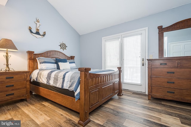 bedroom with lofted ceiling and dark wood-type flooring