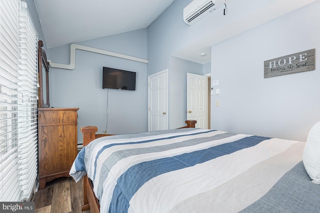 bedroom with wood-type flooring, a wall unit AC, and lofted ceiling