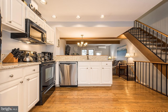 kitchen featuring black appliances, pendant lighting, white cabinets, and kitchen peninsula