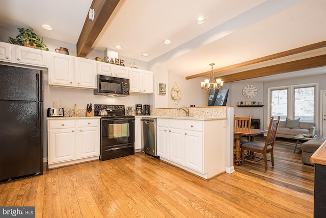 kitchen featuring black appliances, light hardwood / wood-style flooring, beamed ceiling, white cabinetry, and hanging light fixtures