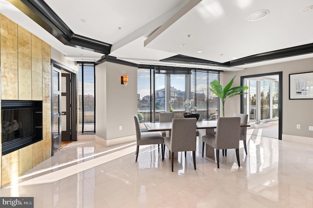 dining space featuring a tile fireplace