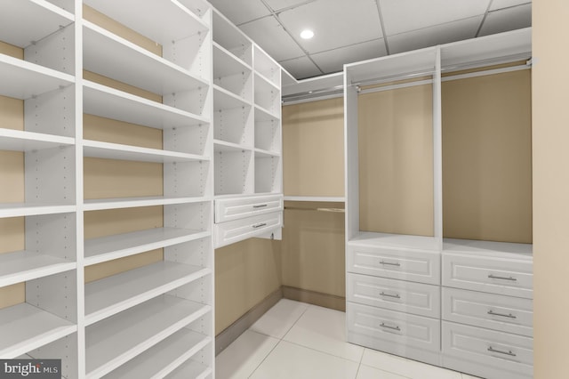 spacious closet with tile patterned flooring and a paneled ceiling