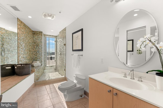 bathroom featuring tile patterned floors, vanity, a shower with shower door, and toilet