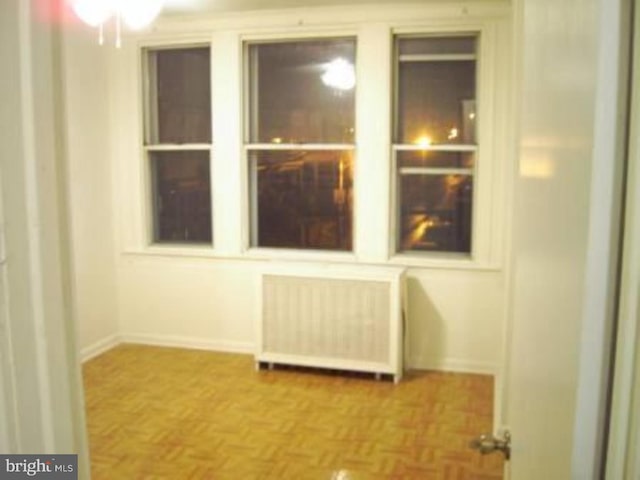 room details with parquet flooring and radiator heating unit