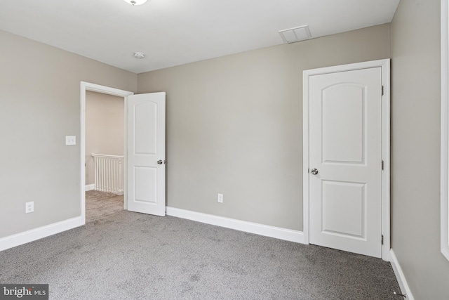 unfurnished room with light colored carpet