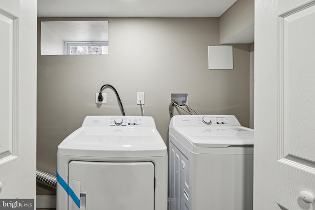 washroom with washing machine and clothes dryer