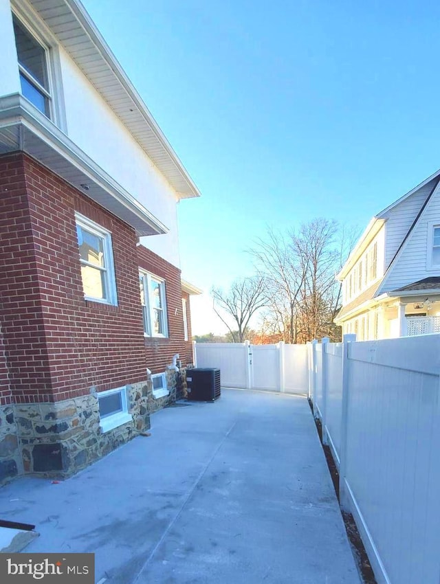 view of side of home with central AC unit