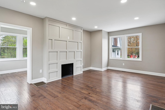 unfurnished living room featuring dark wood-type flooring