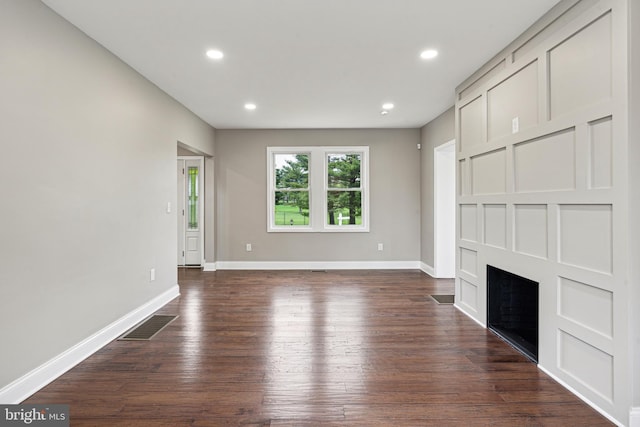 unfurnished living room featuring dark wood-type flooring