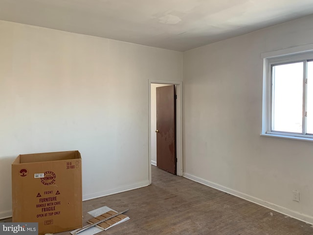 empty room with dark hardwood / wood-style flooring