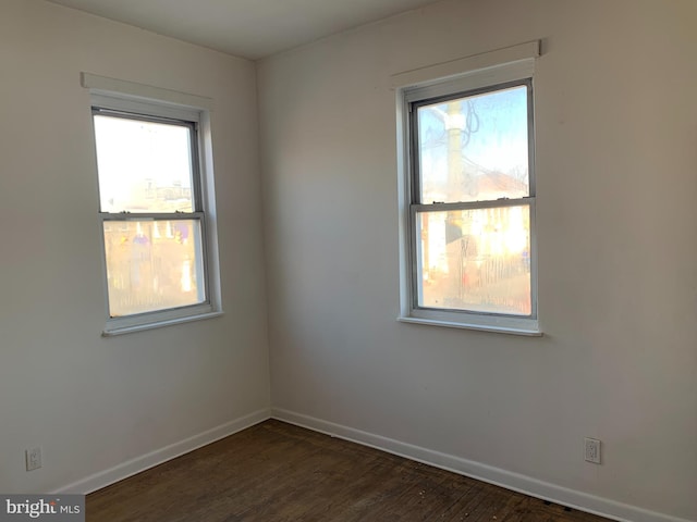 empty room with dark hardwood / wood-style floors