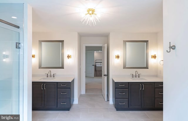 bathroom with tile patterned flooring, vanity, and a chandelier