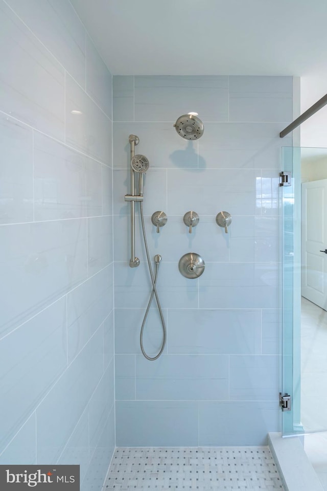 bathroom with a tile shower