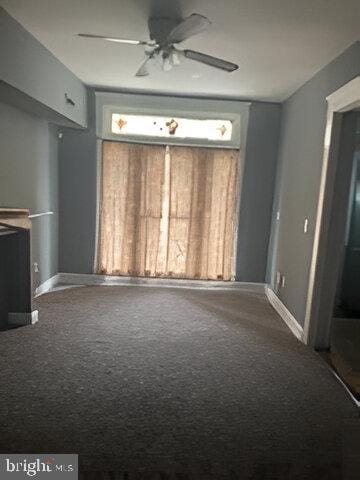 unfurnished living room featuring carpet flooring and ceiling fan