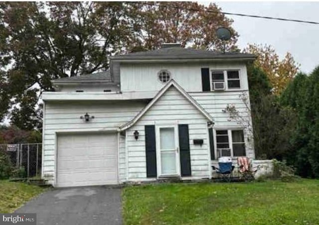 front of property featuring a garage and a front yard