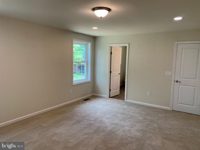 unfurnished bedroom featuring light carpet