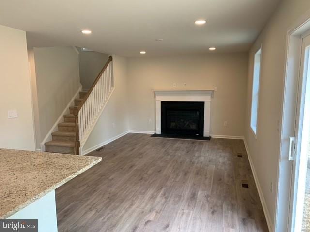 unfurnished living room featuring dark wood-type flooring