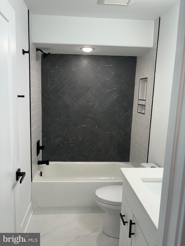 full bathroom with vanity, toilet, and tiled shower / bath