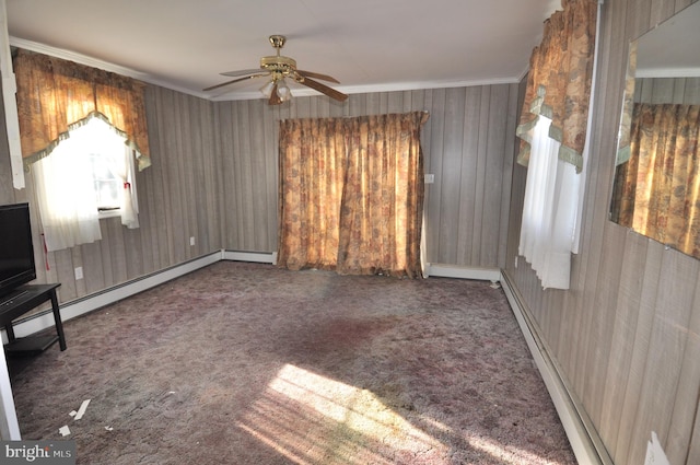 interior space featuring ornamental molding, ceiling fan, carpet flooring, and baseboard heating