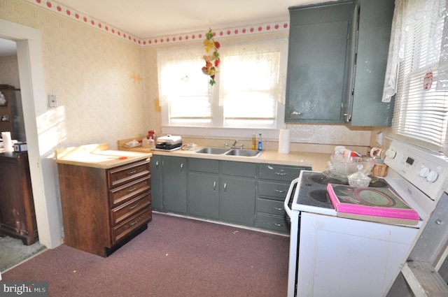 kitchen with sink, white electric stove, and dark carpet