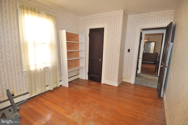 unfurnished bedroom with hardwood / wood-style flooring