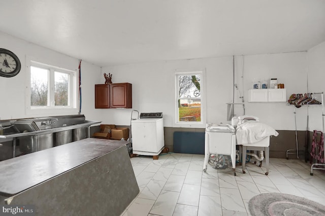 kitchen featuring washer / clothes dryer and a healthy amount of sunlight