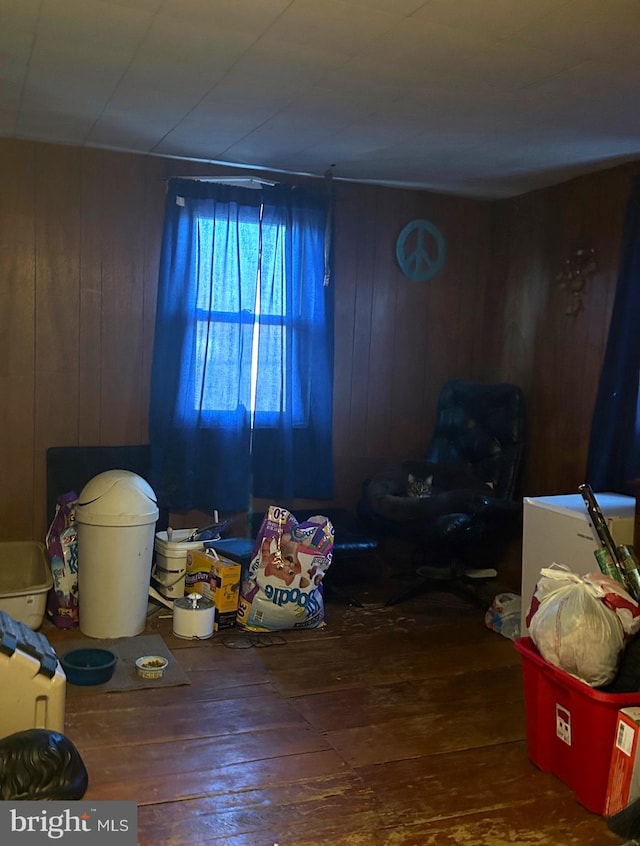 misc room featuring hardwood / wood-style floors and wooden walls