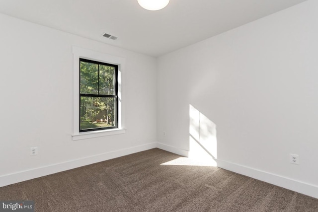 empty room featuring dark carpet