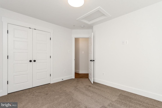 unfurnished bedroom with a closet and carpet floors