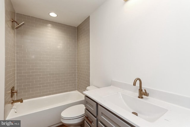 full bathroom featuring vanity, toilet, and tiled shower / bath