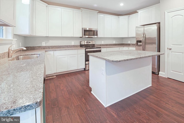 kitchen featuring white cabinets, a kitchen island, dark wood-type flooring, and stainless steel appliances