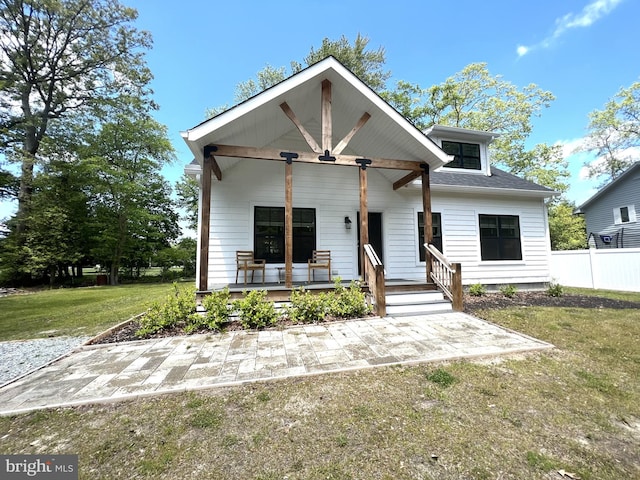 view of front of property with covered porch and a front yard