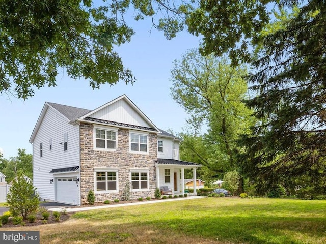 view of front of house featuring a front lawn, a porch, and a garage