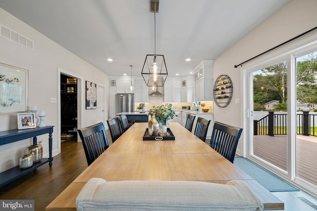 dining space featuring dark hardwood / wood-style flooring and sink