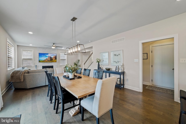 dining area featuring ceiling fan and dark hardwood / wood-style flooring