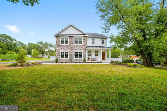 view of front of property with covered porch and a front yard