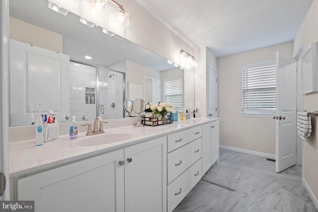 bathroom with vanity and a shower with shower door