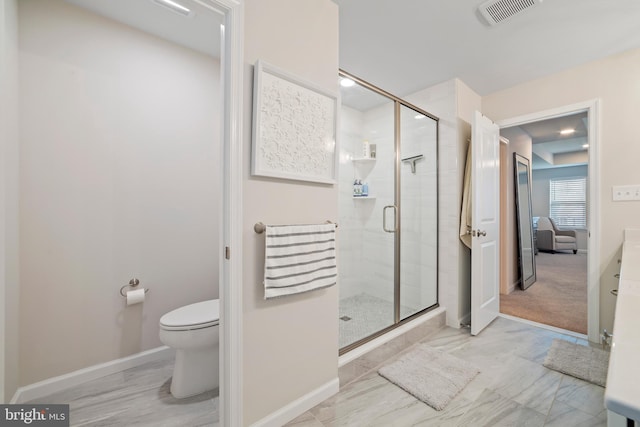 bathroom featuring walk in shower and toilet