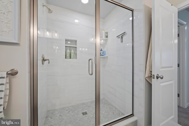 bathroom featuring a shower with door